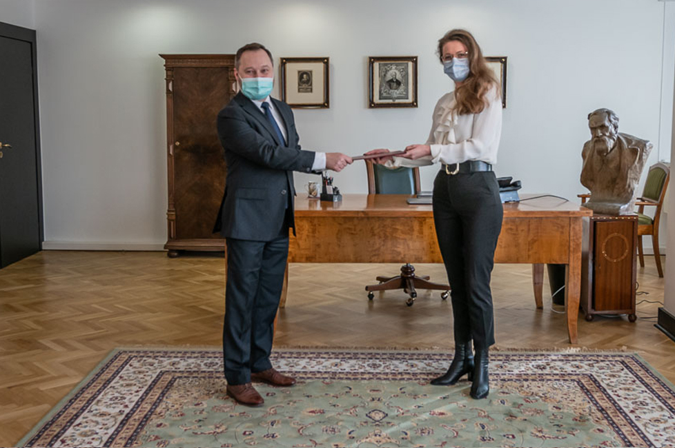 Marta Wojciechowska przyjmuje nominację z rąk dyrektora Biblioteki Narodowej